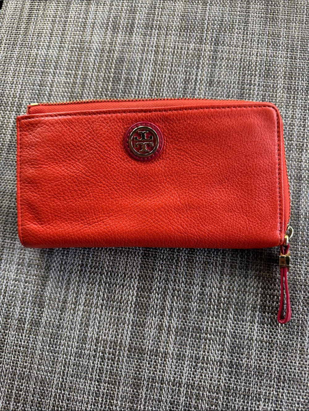 Tory Burch vibrant orange leather zip wallet with logo